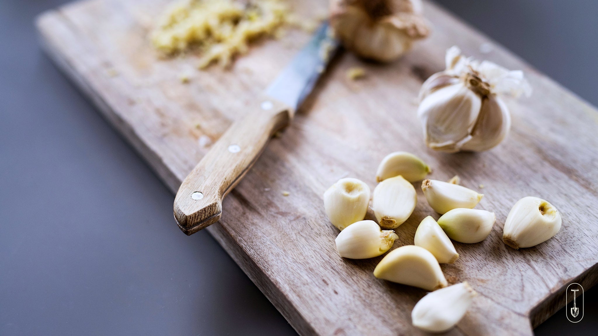 Taiga Farm and Seed Peeled Garlic Cloves Ready on a Cutting Board